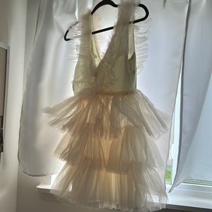 Cream mini dress with tulle ruffles.